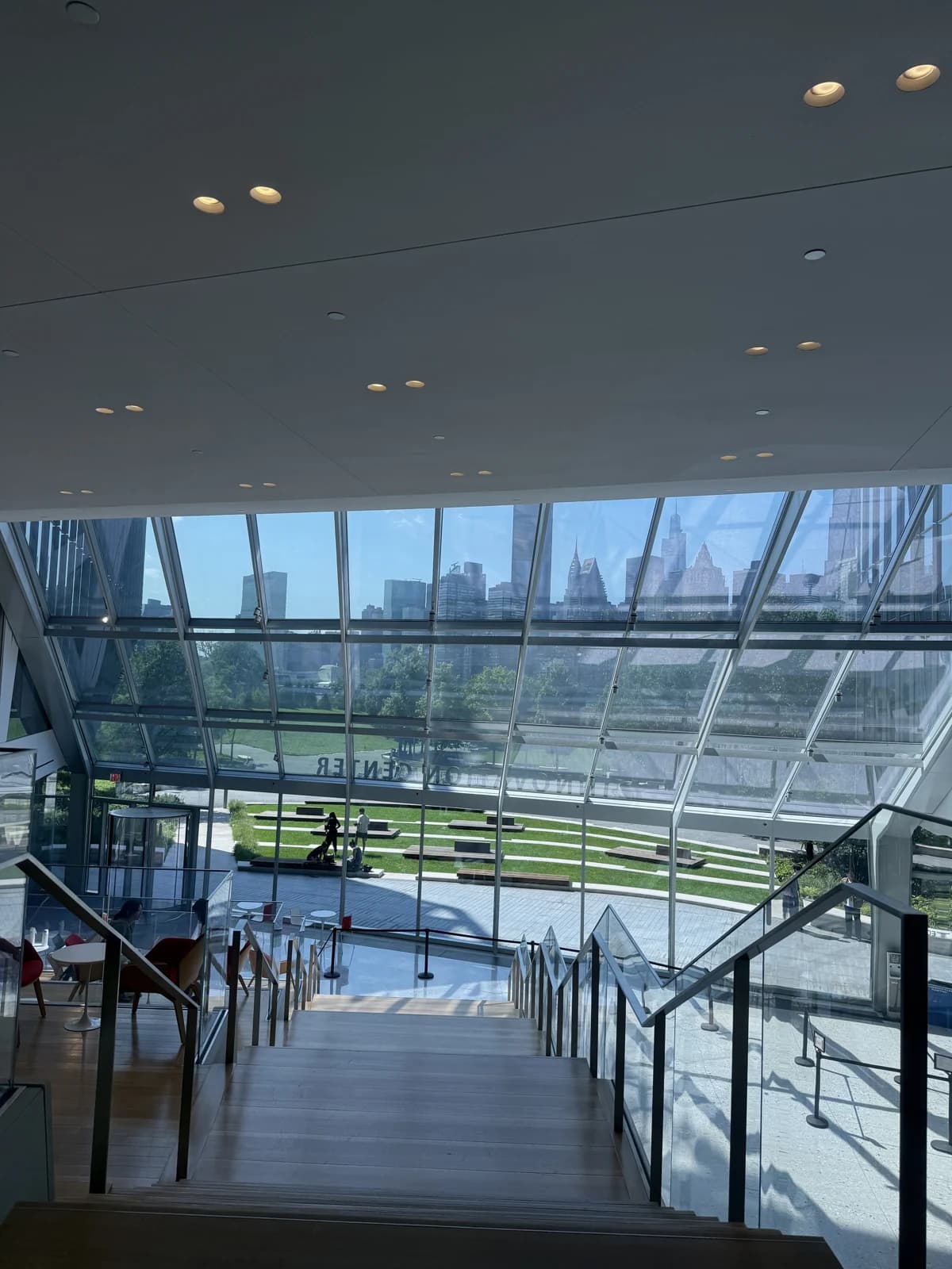 Sunlit glass architecture overlooking trees and the city