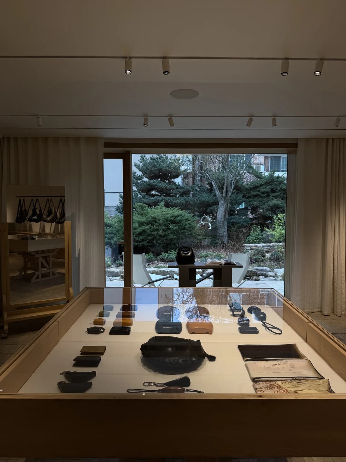 A warm wooden display case overlooking a green courtyard