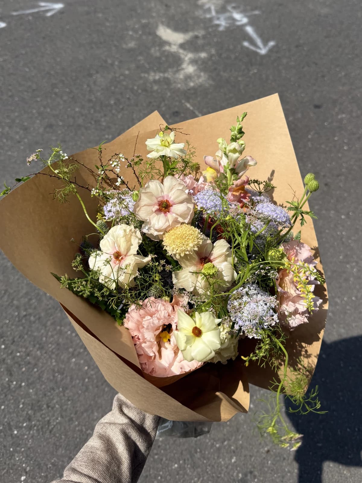 A bouquet of pale pink, yellow, and lavender flowers