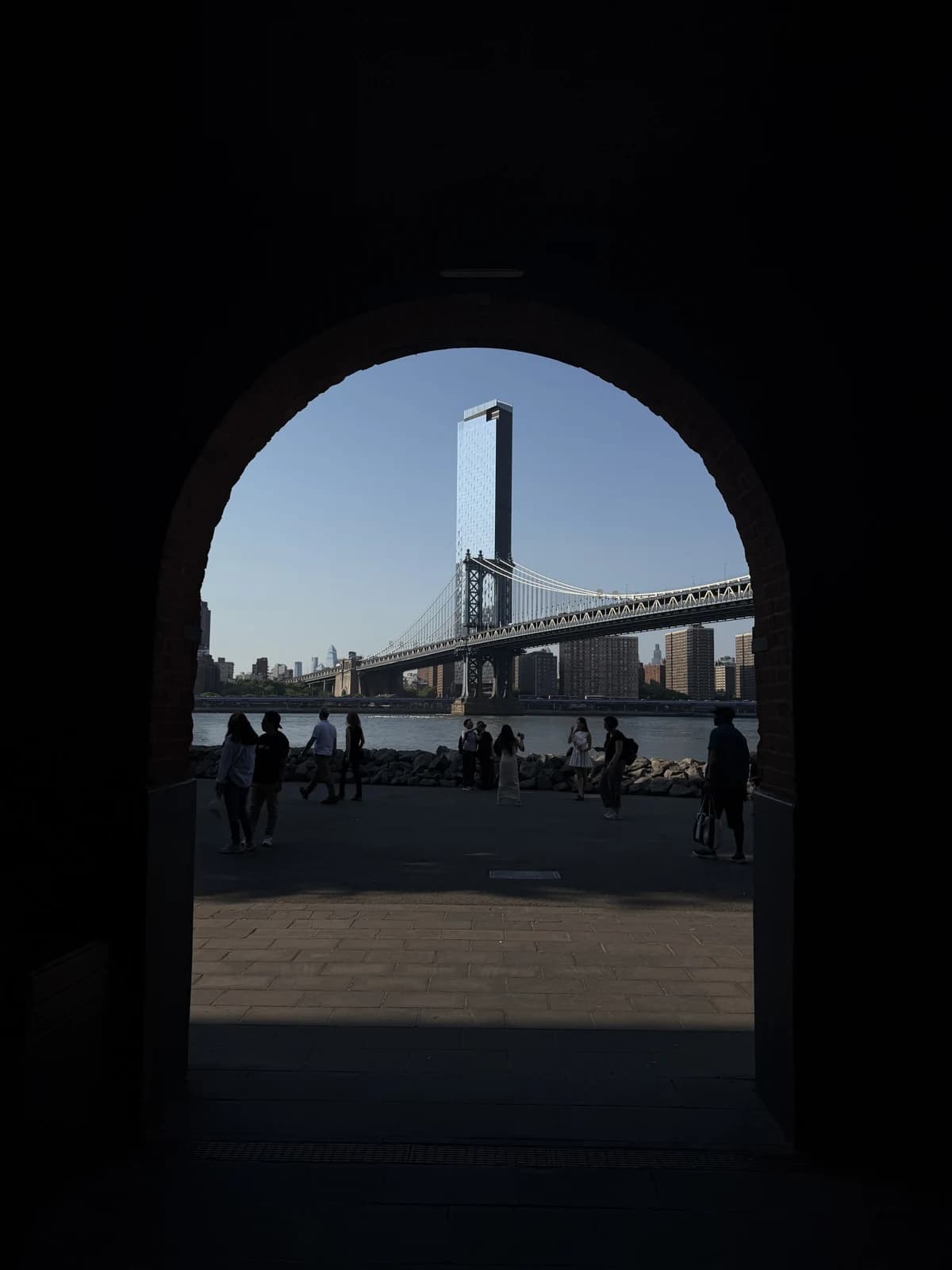 Manhattan Bridge framed by a brick archway