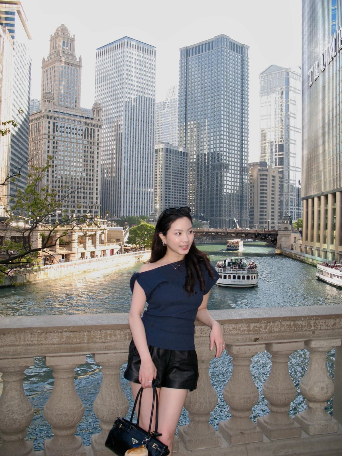 Melody by the Chicago River with boats and city architecture